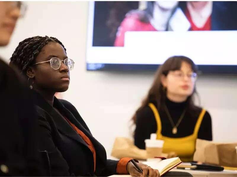 Barnard students in a panel discussion listening to a speaker